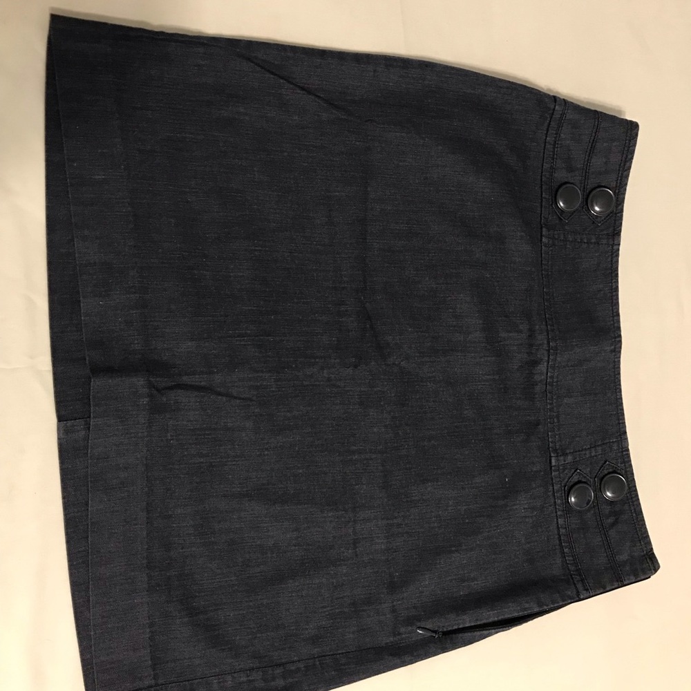 Navy above knee skirt. Button accents on waist.
